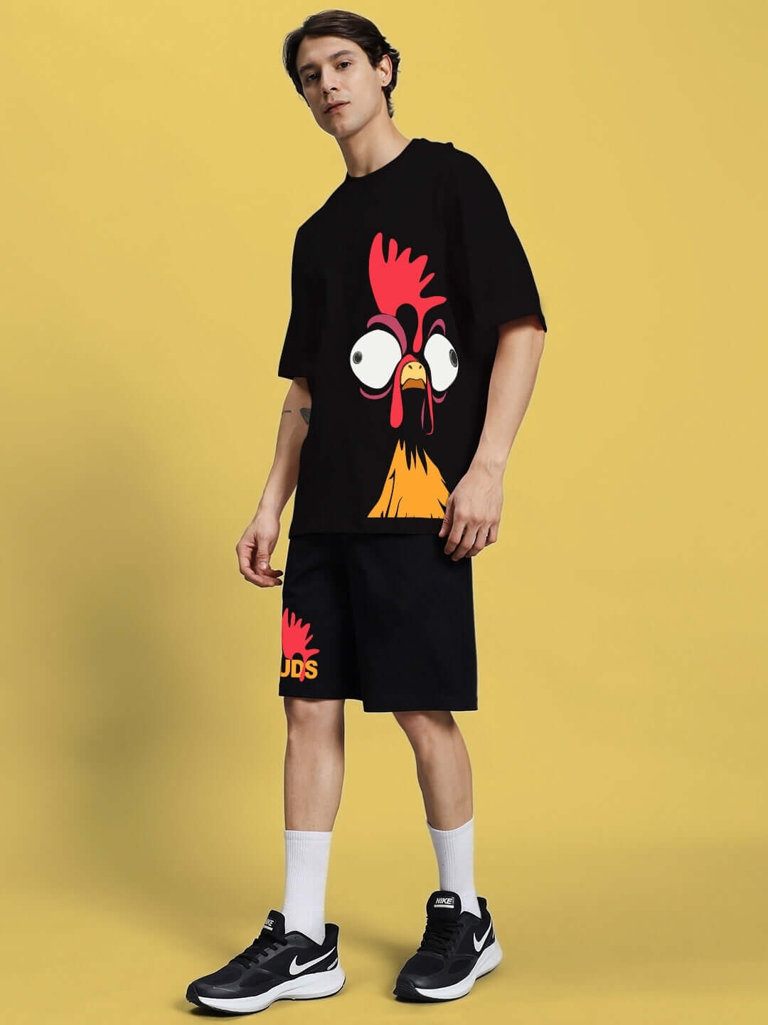 Man wearing FUNNY CHICKEN SUMMER CO-ORD SET BLACK with quirky print on black base, showcasing unique summer fashion.