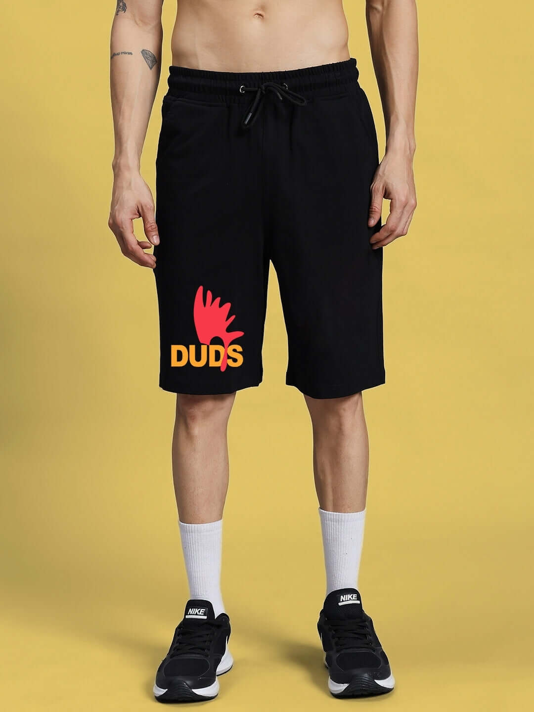 Model wearing FUNNY CHICKEN SUMMER SHORTS BLACK by DUDS, featuring custom fit option and playful chicken design on front.