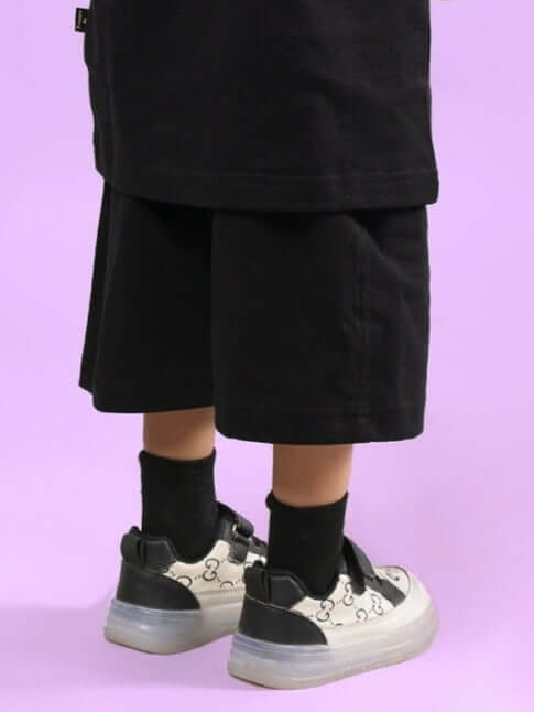 GAME FINISHER SHORTS FOR BOYS & GIRLS BLACK, made to order with custom fit option, shown on model with sneakers, back view.