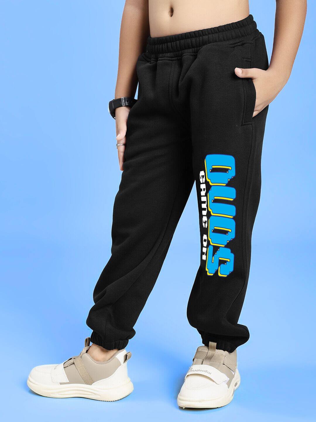 Child wearing GAME ON PRINT FLEECE CO-ORD FOR BOYS AND GIRLS BLACK with bold graphic lettering, showcasing sporty style and comfort.