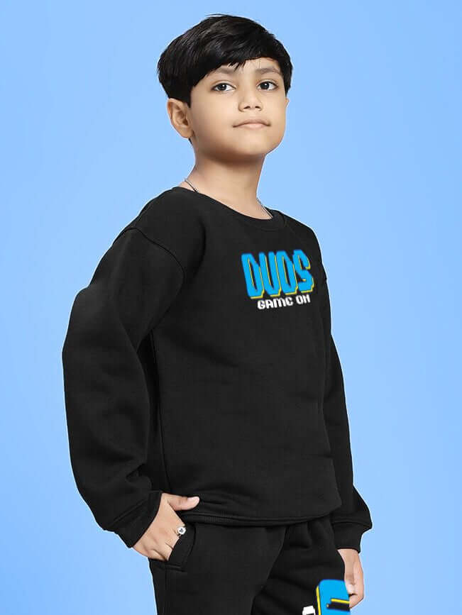 Boy wearing GAME ON PRINT FLEECE SWEATSHIRT FOR BOYS GIRLS BLACK with bold graphic design, showcasing sporty and casual style.