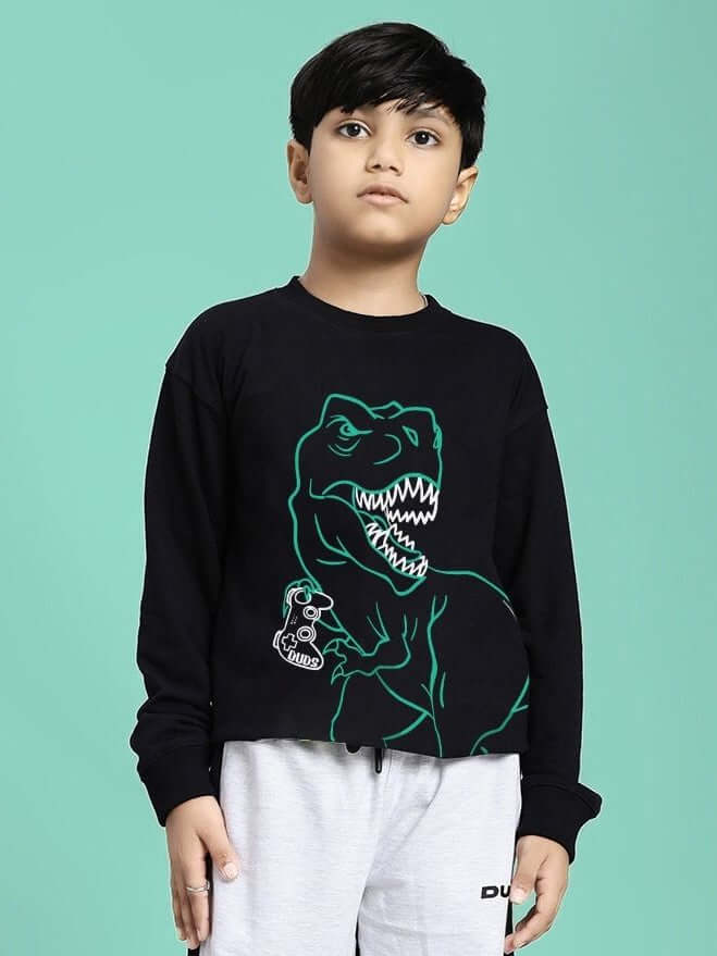Child wearing the GAMEING REX PRINT SWEATSHIRT FOR BOYS GIRLS BLACK with dinosaur graphic on black background.