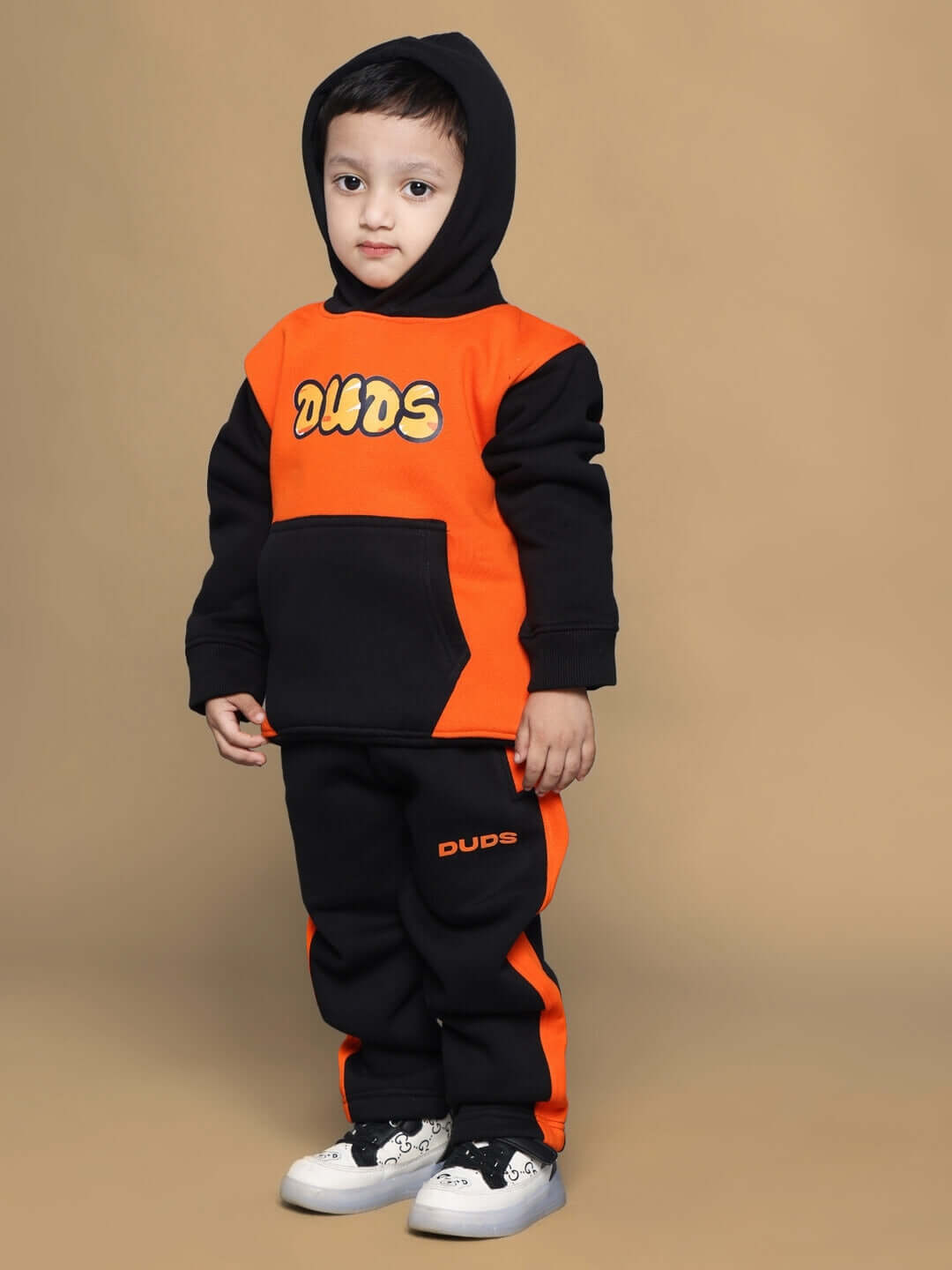 Child wearing black and orange COOL TEDDY Fleece Pant for boys and girls, featuring a playful design and warm fabric.