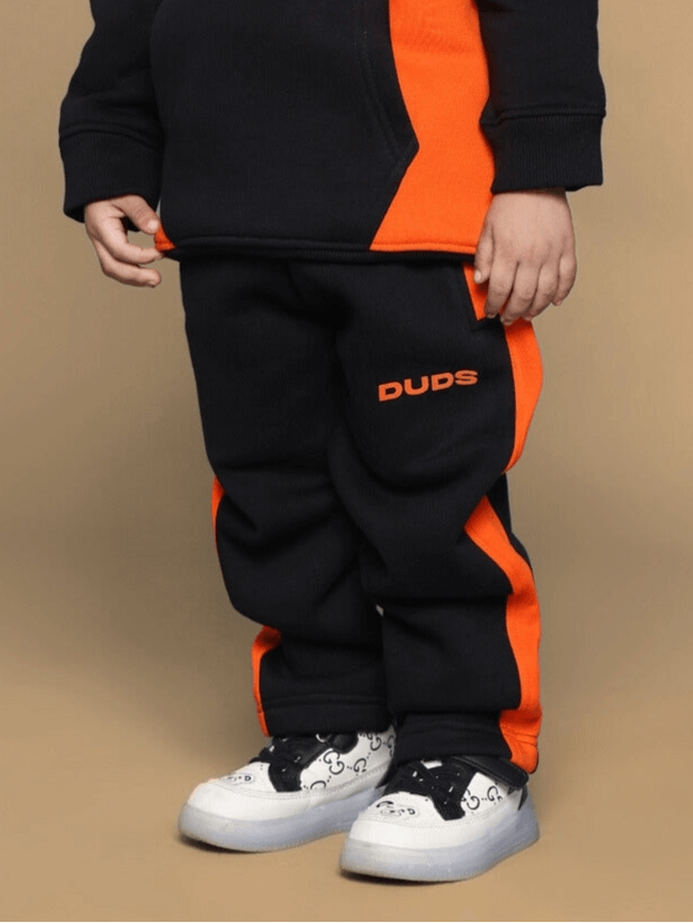 Black and orange teddy fleece pants for boys and girls, featuring comfortable fit and stylish design.
