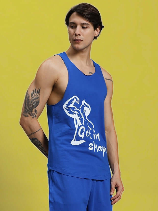 GET IN SHAPE GYM T-SHIRT ROYAL BLUE showcasing a man wearing athletic apparel with motivational design, perfect for fitness enthusiasts.