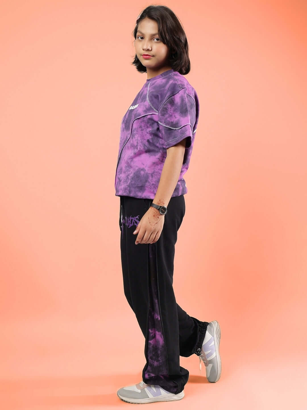 Boy wearing GHOST RIDER CO-ORD FOR BOYS & GIRLS PURPLE BLACK clothing set, standing sideways on orange background