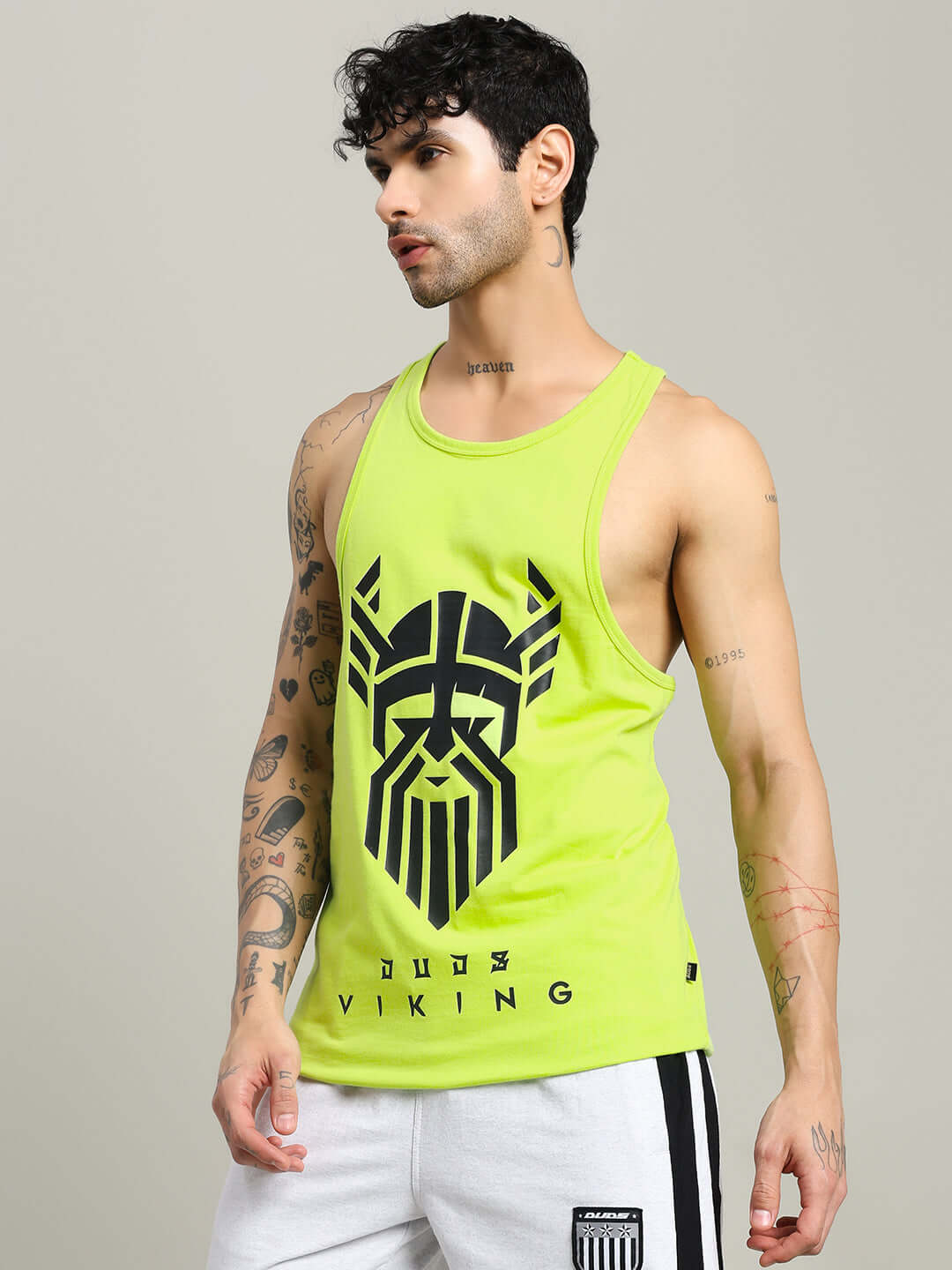 Man wearing GLADIATOR GYM T-SHIRT in neon green with Viking logo, showcasing athletic style and custom fit option for DUDS brand.