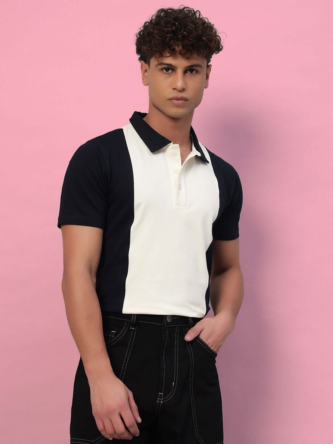 Man wearing GLORY REGULAR FIT T-SHIRT NAVY BLUE with panel design on a pink background