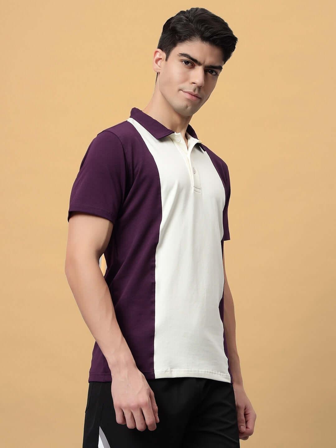 Man wearing GLORY REGULAR FIT T-SHIRT PURPLE-OFF WHITE with colorblock design, breathable cotton, showcasing a stylish and comfortable fit.