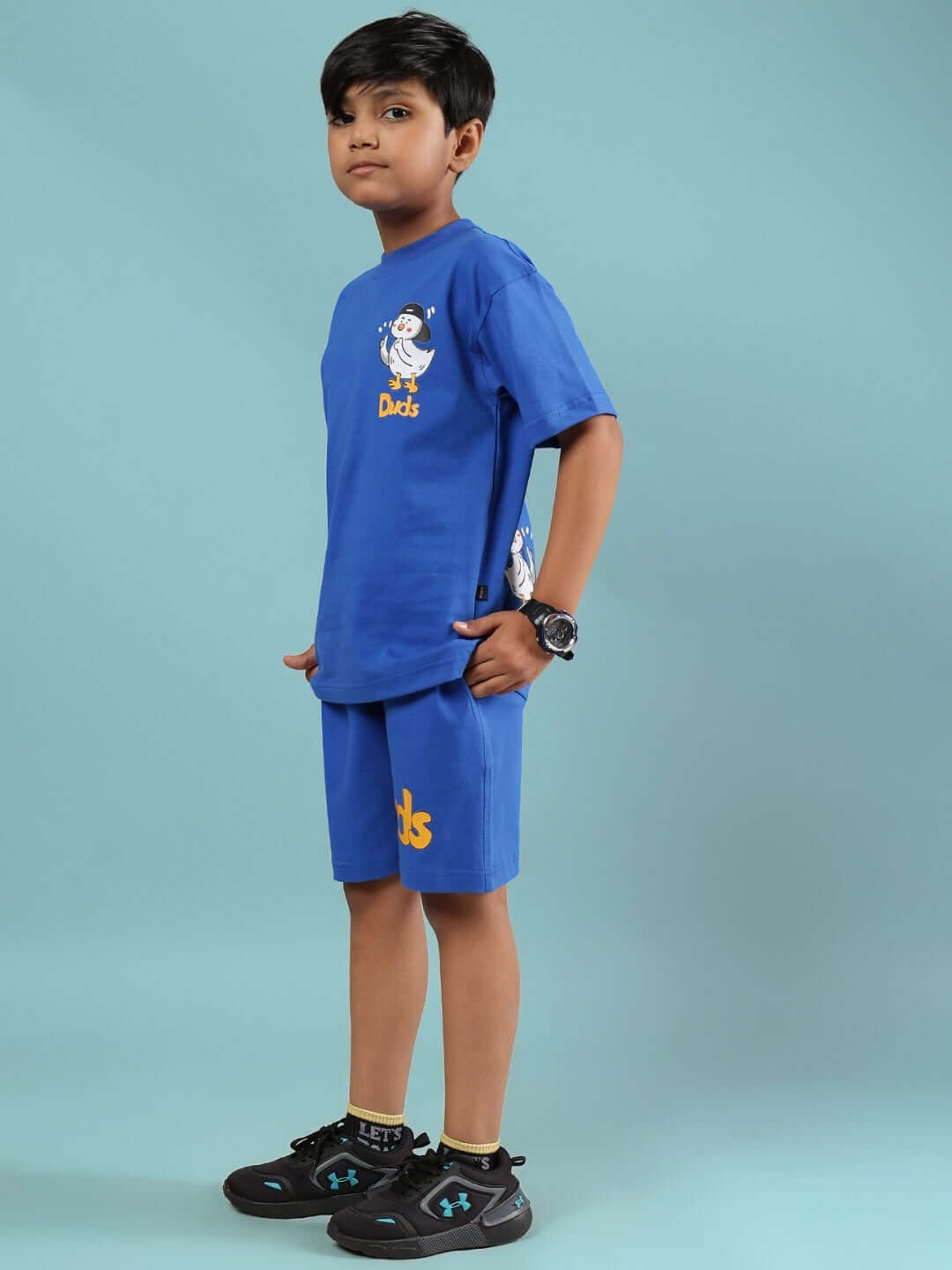 Young boy wearing Go Motion Co-ord set in royal blue by Duds; tailor-made outfit for boys and girls with custom fit option.