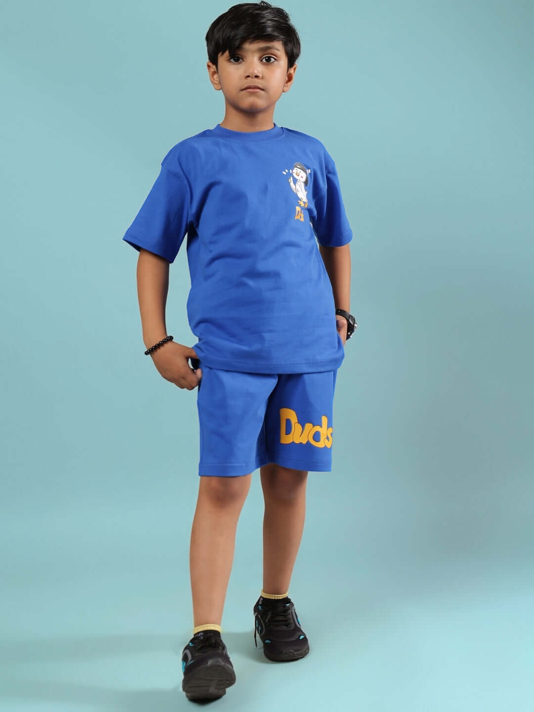 Child wearing Go Motion Royal Blue Shorts for Boys & Girls by DUDS.