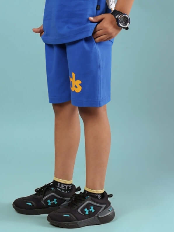GO MOTION SHORTS FOR BOYS & GIRLS ROYAL BLUE on child, showcasing sporty design and comfort.