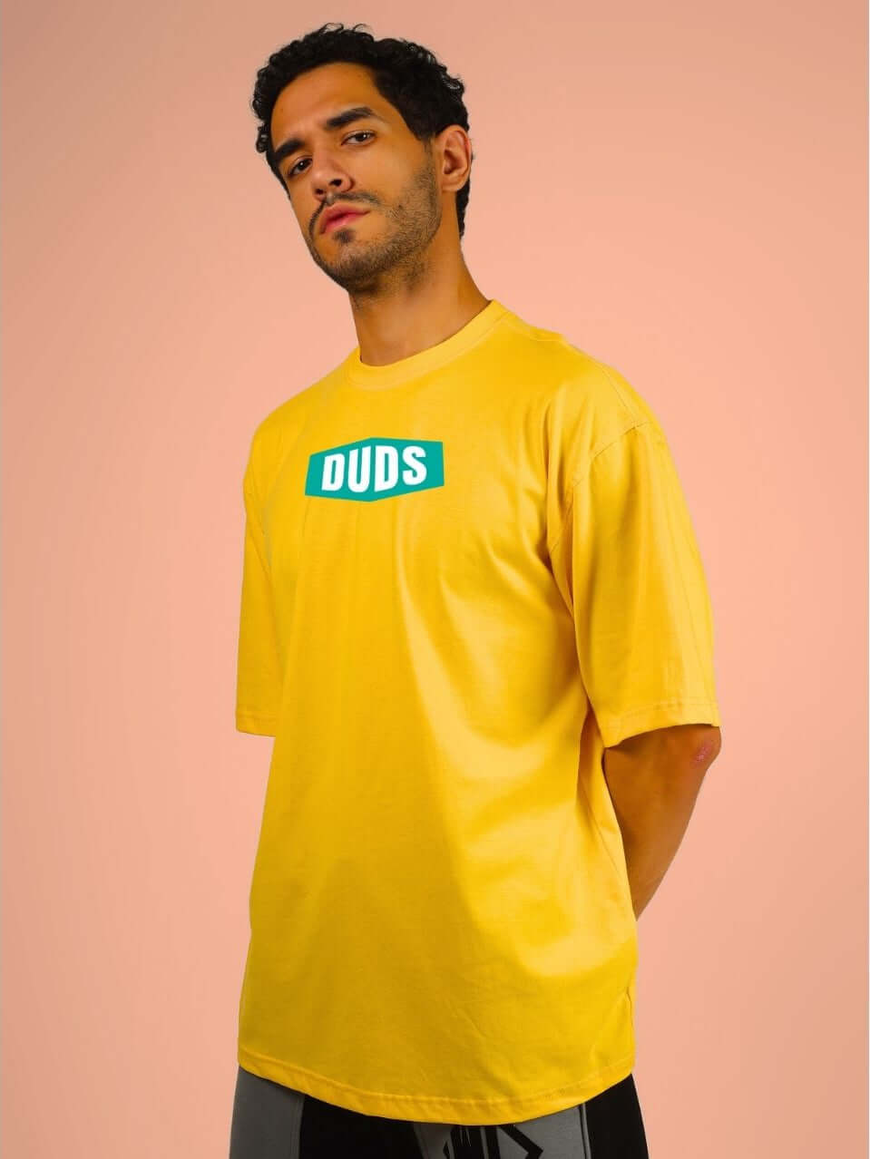 Model wearing GO WILD ADVENTURE OVER-SIZED T-SHIRT YELLOW with bold graphic, showcasing vibrant and adventurous style.