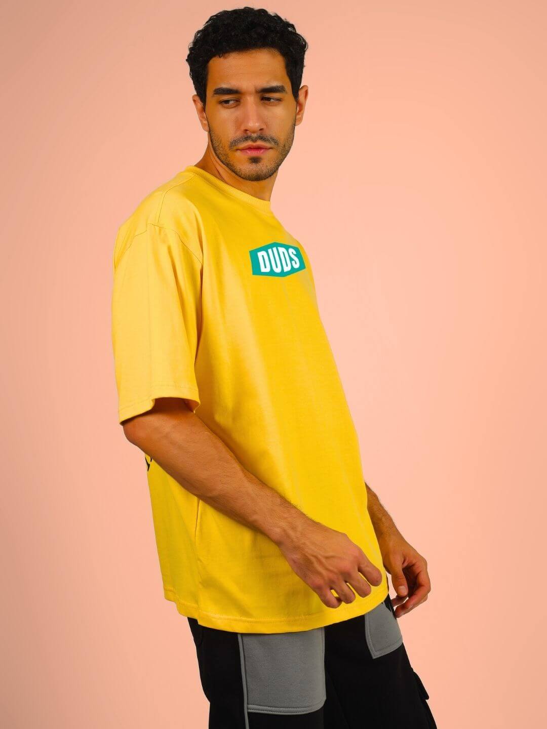 Man wearing GO WILD ADVENTURE OVER-SIZED T-SHIRT YELLOW, showcasing bold design and adventurous spirit, perfect for fearless individuals.