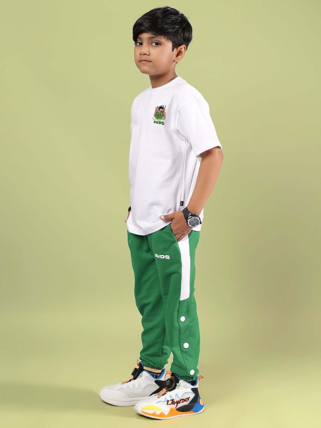 Boy wearing Goku and Bulma printed white and green co-ord set from DUDS, featuring customizable size options for a perfect fit.
