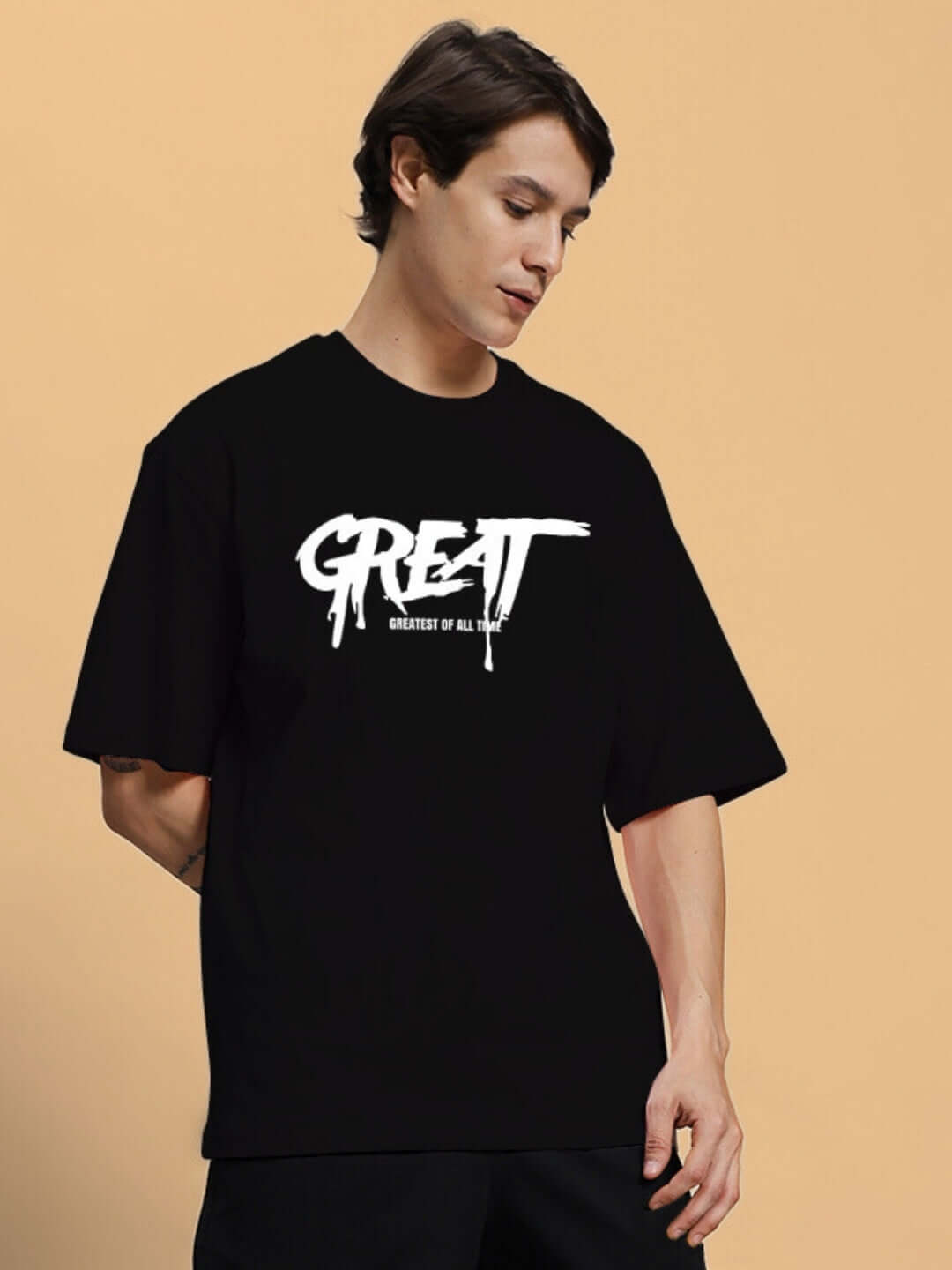 Model wearing GREAT PRINTED OVERSIZED T-SHIRT BLACK with white text design on front, made from premium 100% cotton, bio-washed fabric.