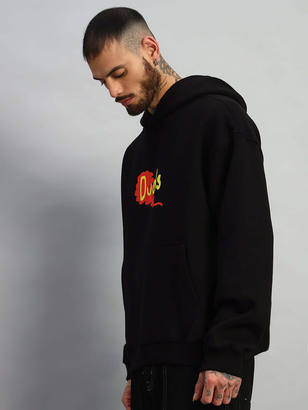 Man wearing Great Ride oversized fleece hoodie in black with colorful front logo, side view, displaying relaxed and casual style.