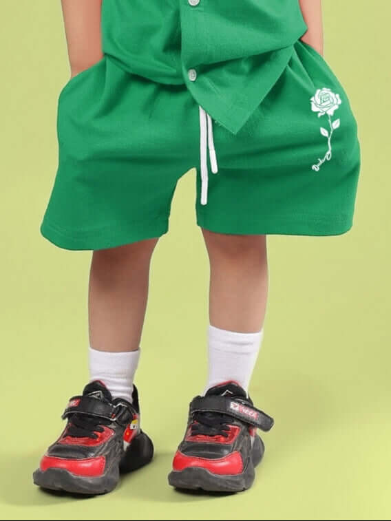 Child wearing LIMBO SHORTS FOR BOYS & GIRLS GREEN, showcasing comfort and style with breathable cotton-blend fabric.