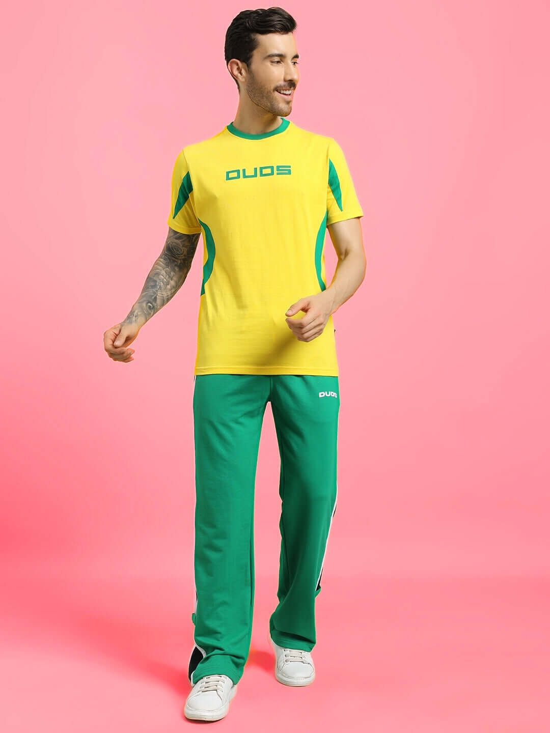 Man modeling green ROSSTON FLAT-OUT RELAXED FIT JOGGERS with a casual yellow sports t-shirt.