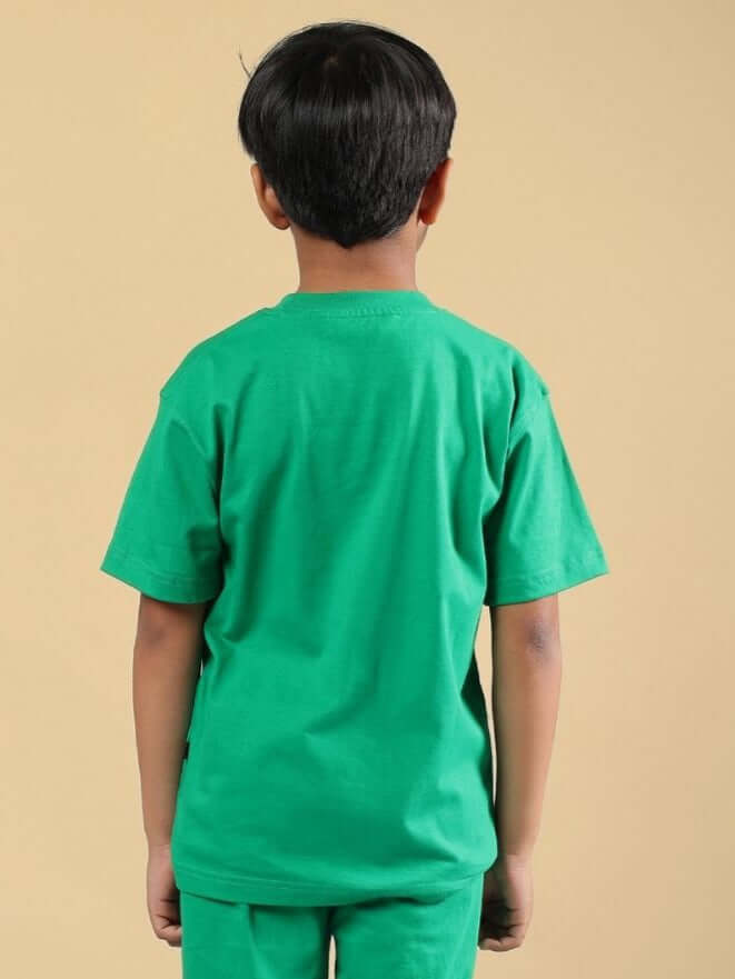 Back view of child wearing green SKELETON RIDER CAR PRINT T-SHIRT FOR BOYS AND GIRLS GREEN, made from soft, breathable cotton-blend fabric.