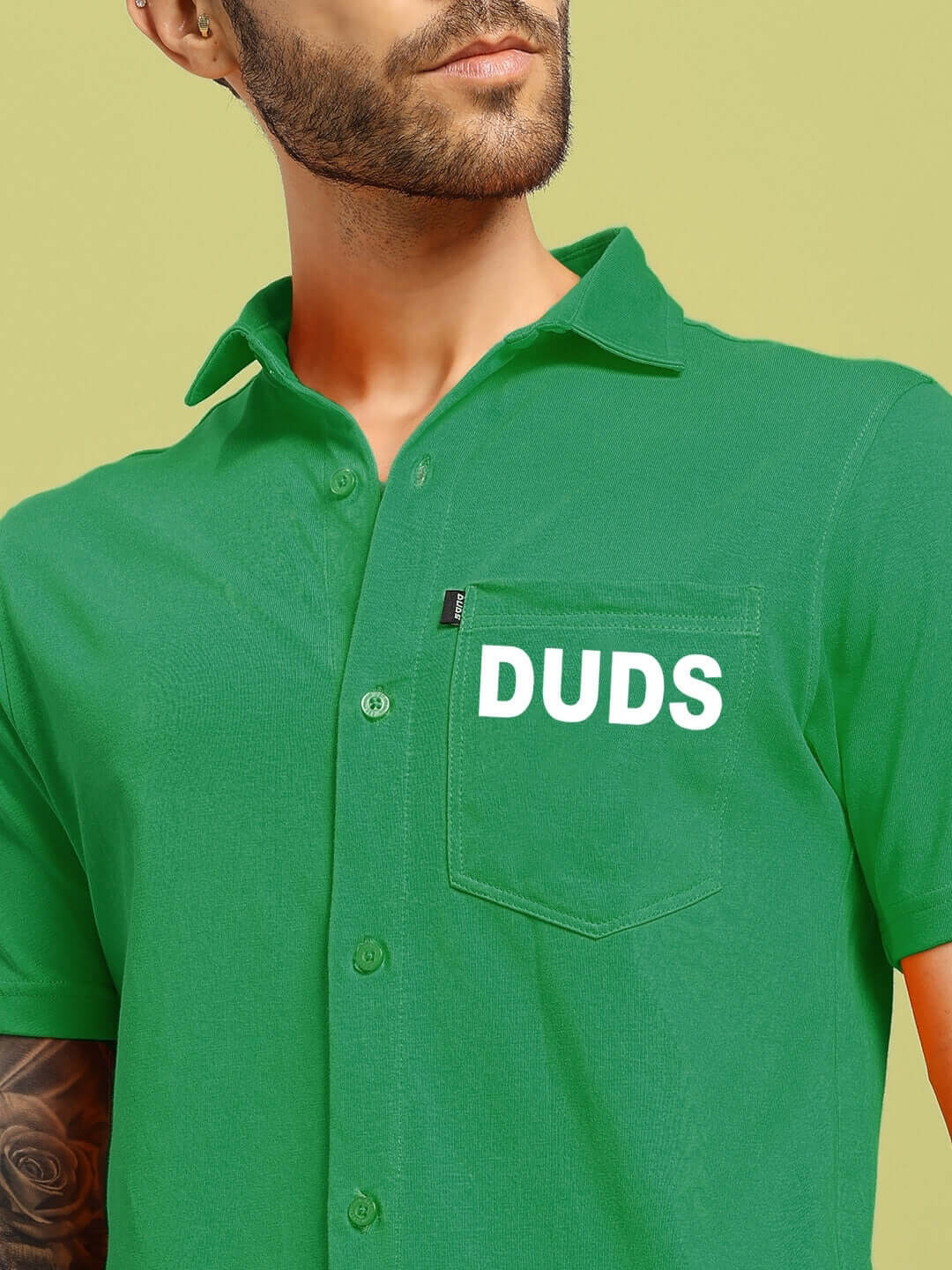 Model wearing DUDS green Wings Tee, regular fit shirt, showcasing vibrant style and comfortable fabric.