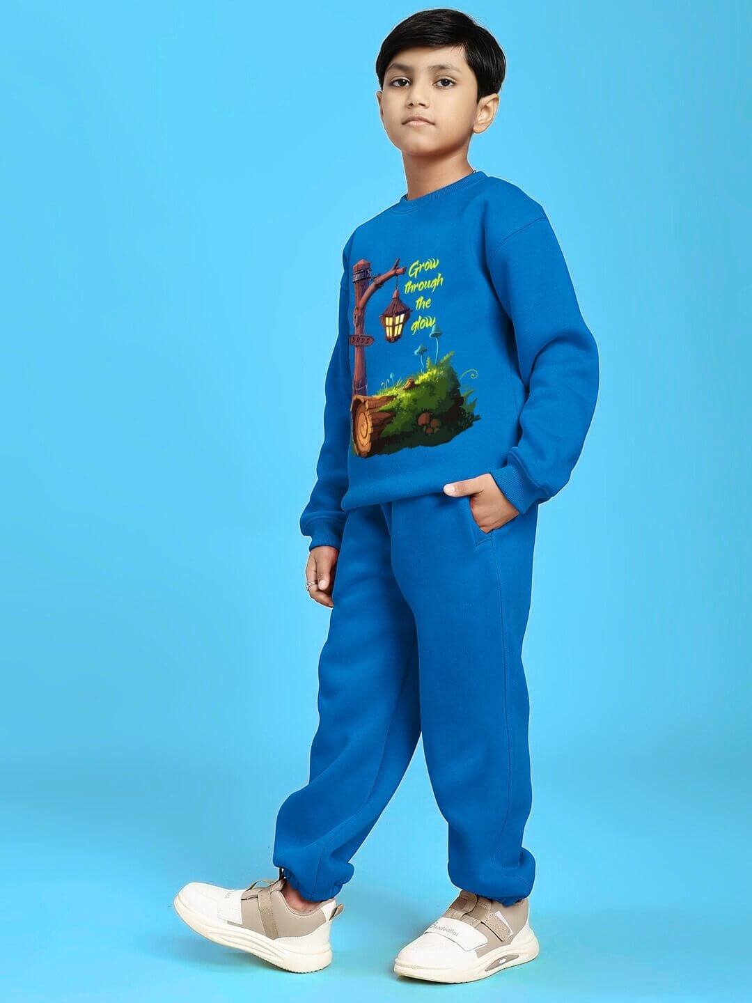 Child wearing Grow and Glow Print Fleece Co-ord for Boys and Girls Blue, showcasing cozy design and vibrant color