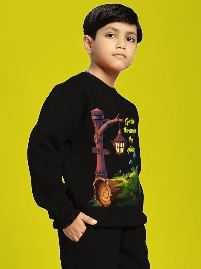 Child wearing GROW AND GLOW PRINT FLEECE SWEATSHIRT FOR BOYS GIRLS BLACK with colorful design on front.
