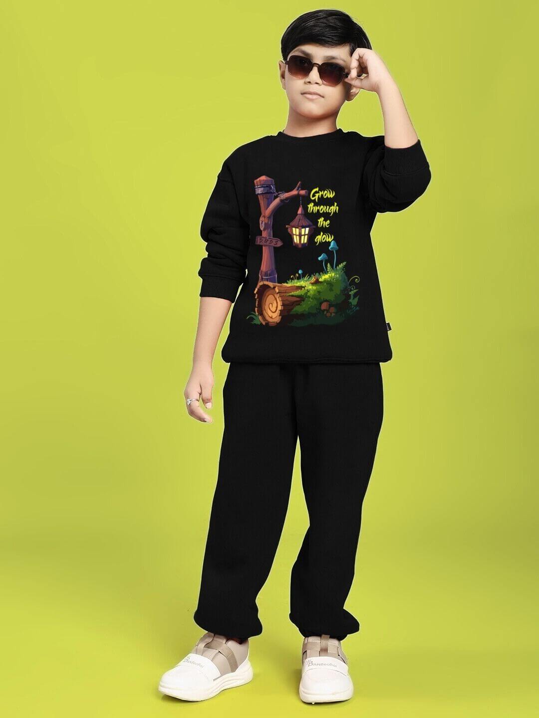 Child wearing Grow and Glow Print Fleece Co-ord for Boys and Girls Black, featuring colorful nature design, standing confidently.