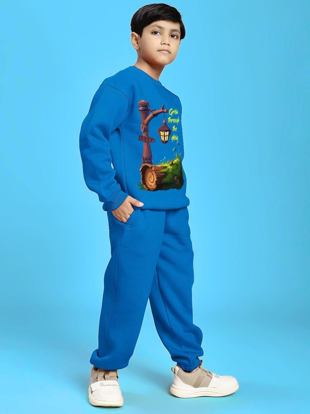 GROW AND GLOW PRINT FLEECE CO-ORD FOR BOYS AND GIRLS BLUE with playful design, shown on a child, perfect for warmth and comfort.