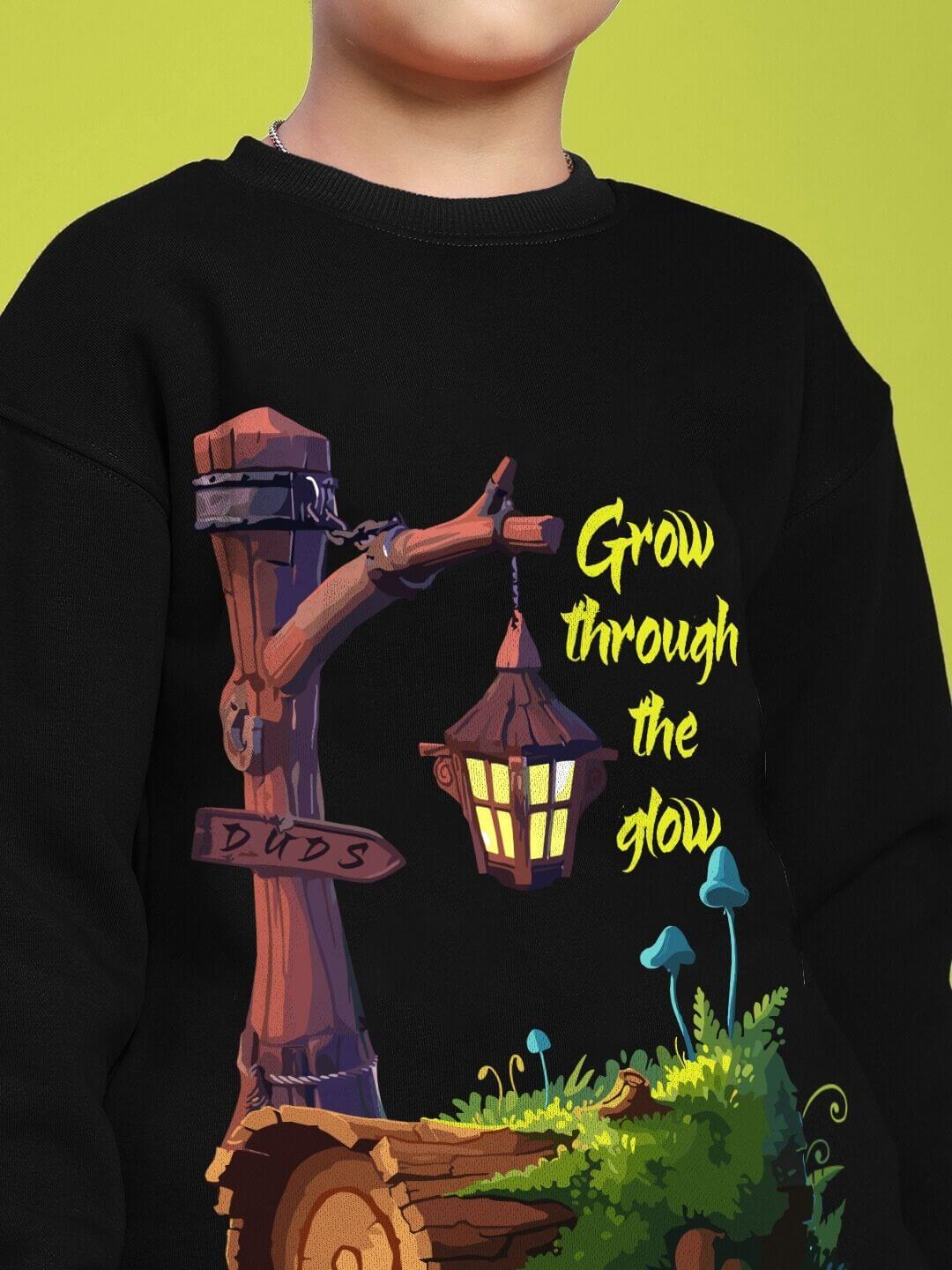 Child wearing GROW AND GLOW PRINT FLEECE CO-ORD FOR BOYS AND GIRLS BLACK with motivational print and cozy design.