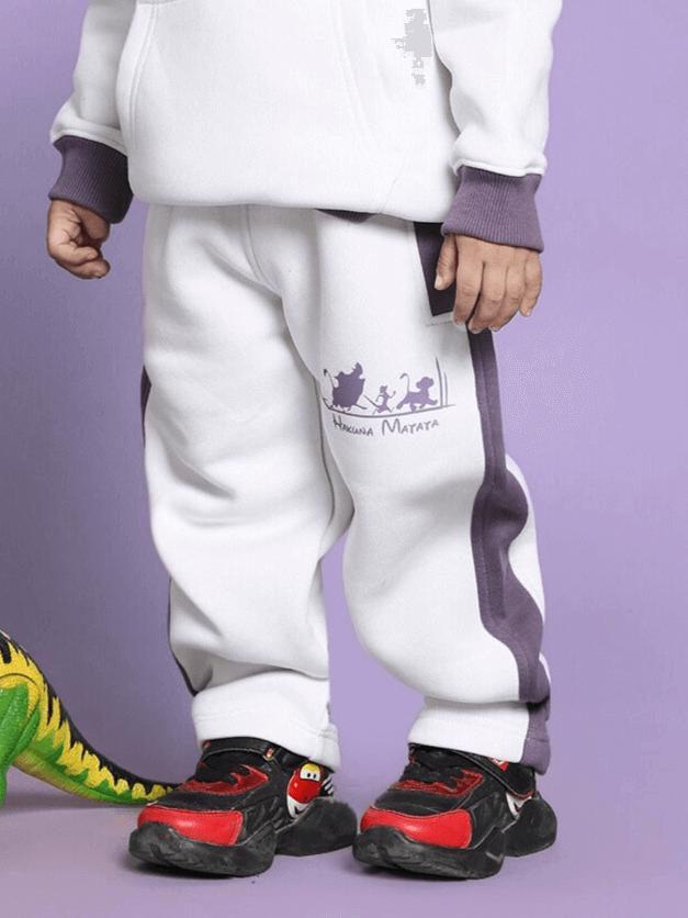 Child wearing Hakuna Matata fleece pants, white-violet, with purple trim; ideal for boys and girls.