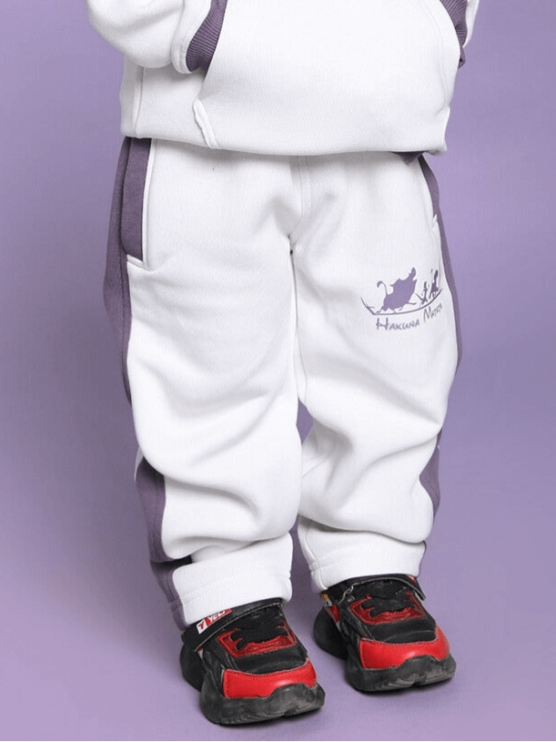 Child wearing Hakuna Matata fleece pant in white and violet, front view, showcasing comfortable and stylish kids' clothing.