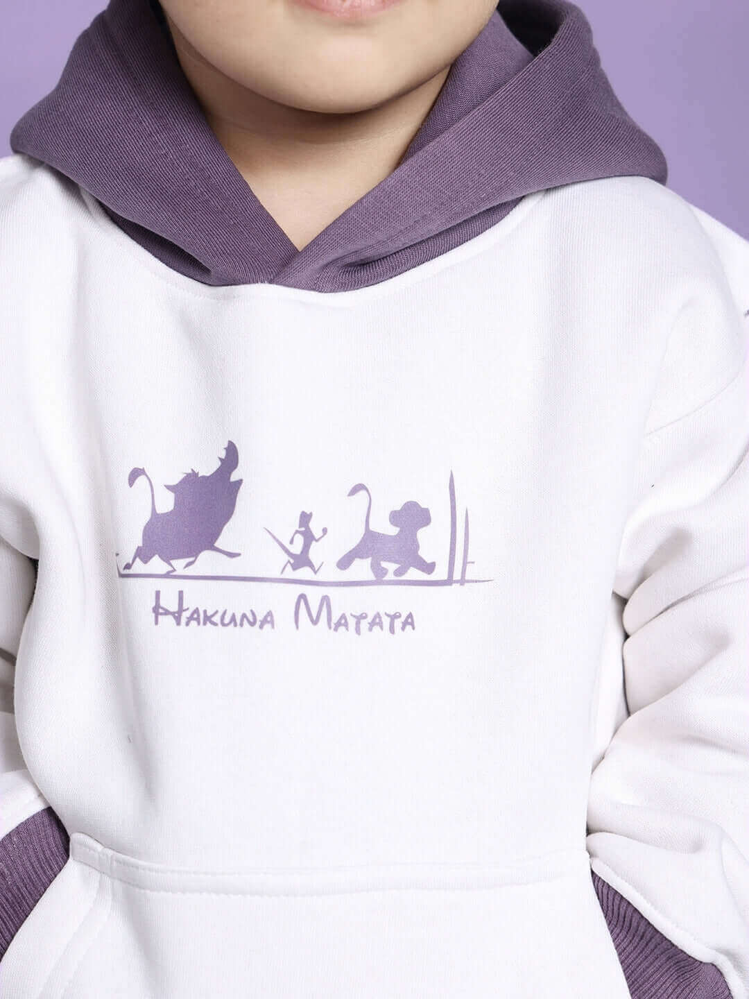 Child wearing Hakuna Matata oversized hoodie in white-violet with playful animated design.