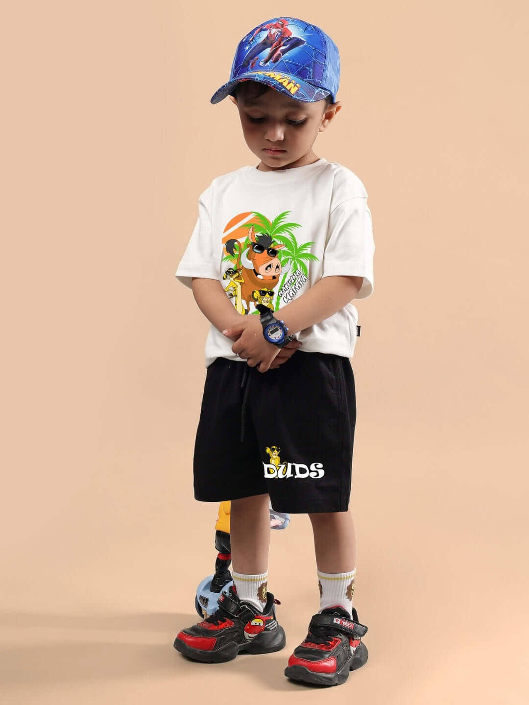 Child wearing HAKUNA MATATA OVERSIZED T-SHIRT FOR BOYS & GIRLS OFF WHITE with cartoon design.