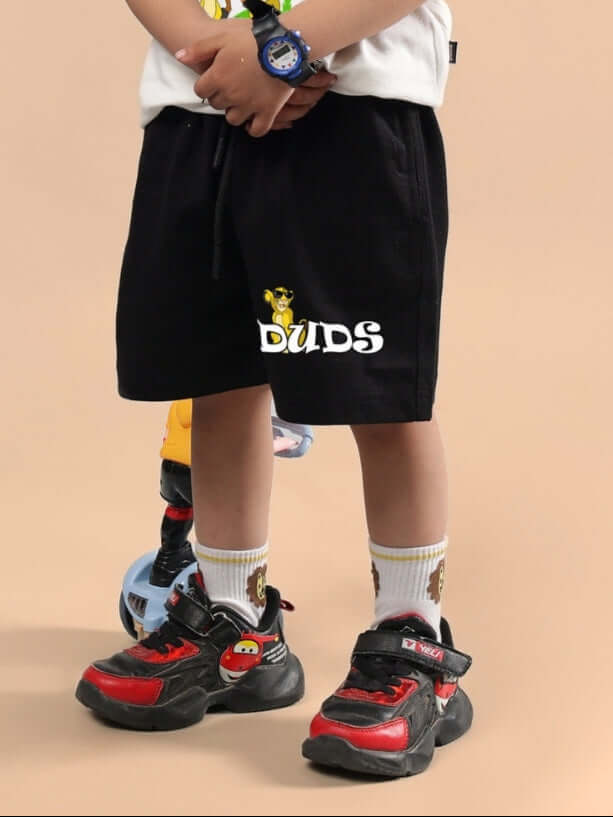 Child wearing HAKUNA MATATA SHORTS FOR BOYS & GIRLS BLACK by DUDS, featuring customizable options and comfortable fit, perfect for kids.