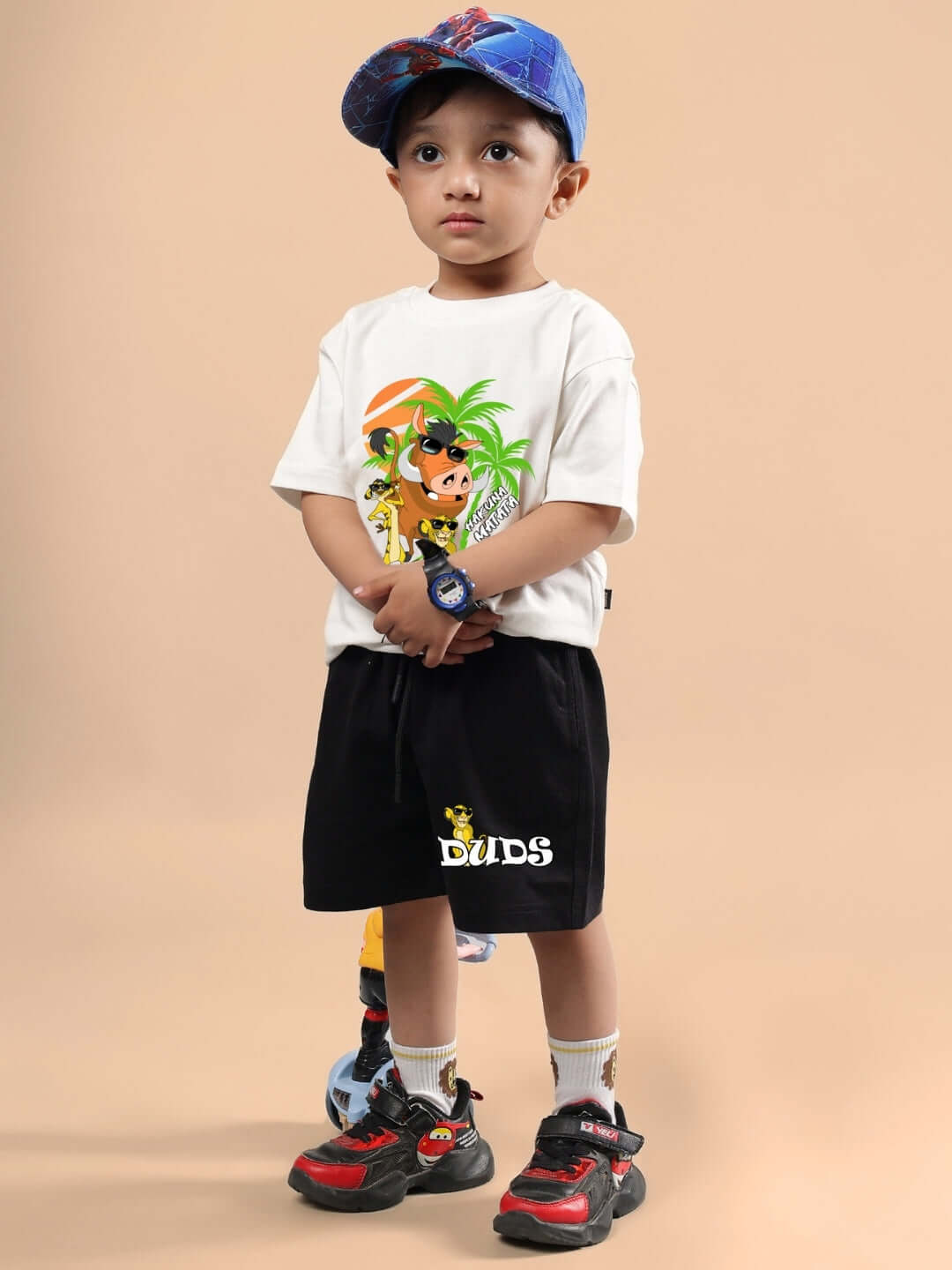 Young child wearing Hakuna Matata Shorts for Boys & Girls Black, with a playful design. Ideal for everyday wear. Order yours now from DUDS.