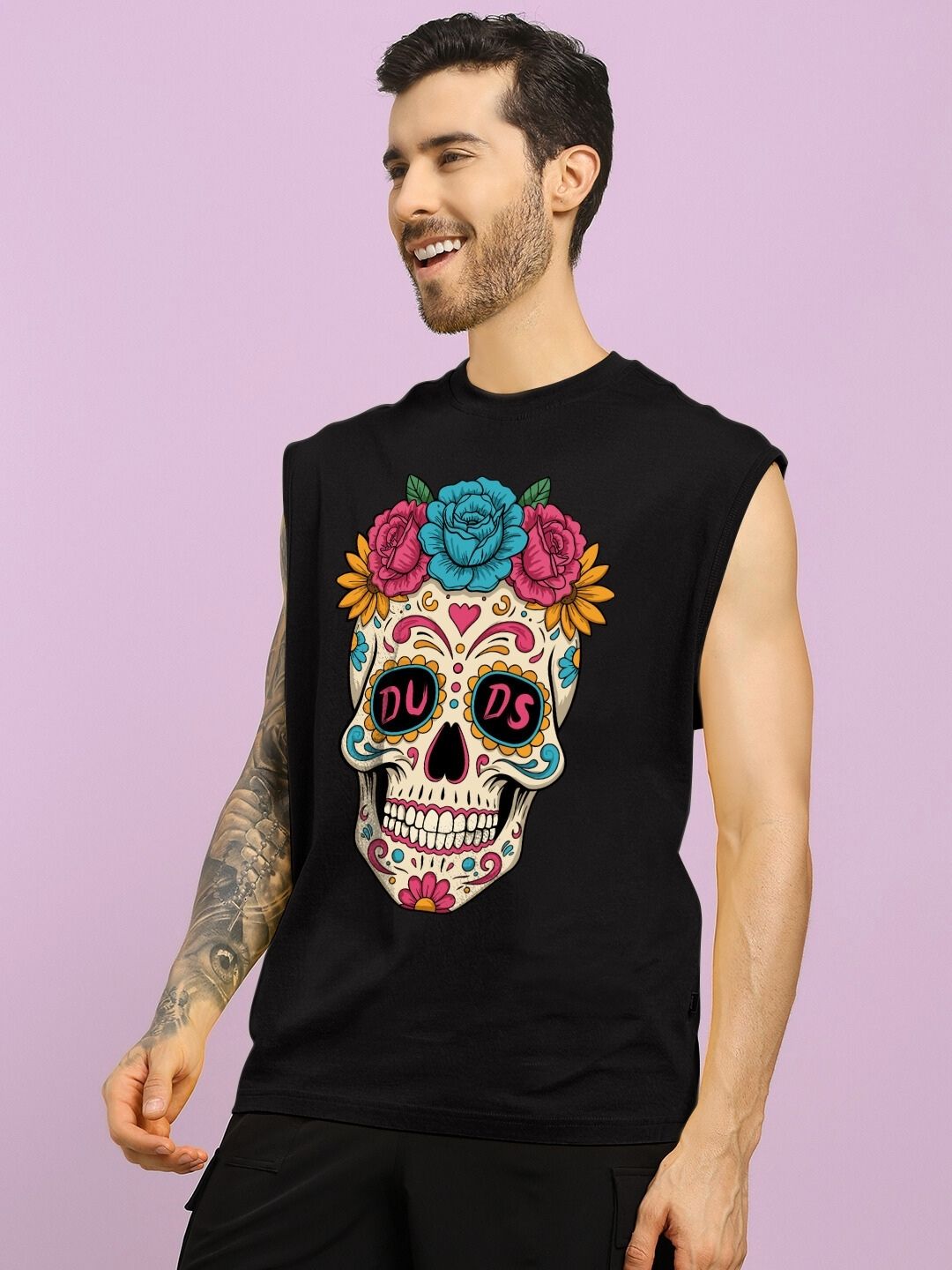 Man wearing HAPPY SKULL PRINTED GYM T-SHIRT BLACK with colorful skull design on purple background.
