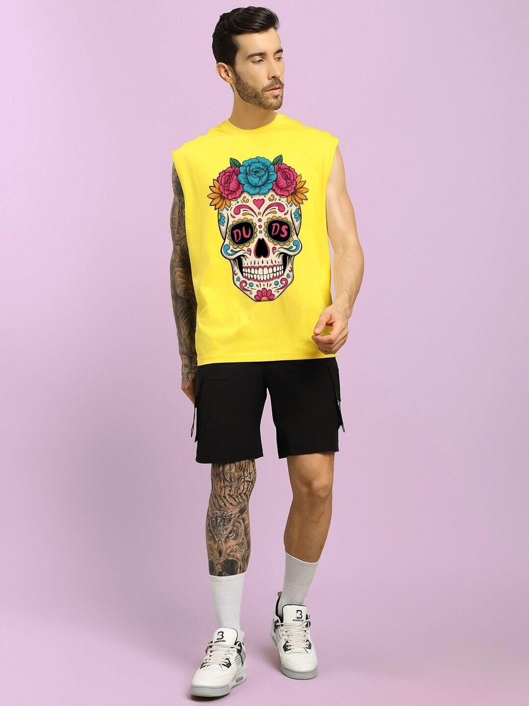 Man wearing HAPPY SKULL PRINTED GYM T-SHIRT YELLOW with vibrant skull design, showcasing edgy streetwear vibe.