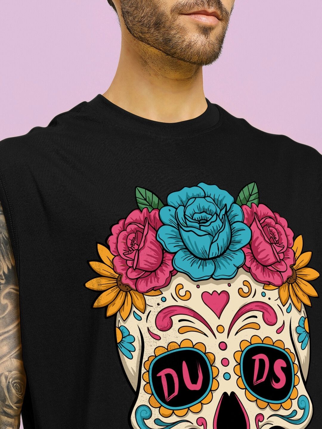 Man wearing HAPPY SKULL PRINTED GYM T-SHIRT BLACK featuring colorful skull design with roses, sunflowers, and decorative patterns.