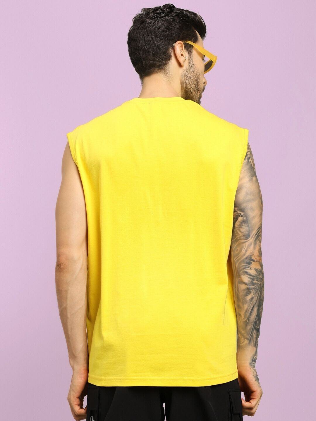 Back view of model wearing HAPPY SKULL PRINTED GYM T-SHIRT YELLOW, showcasing edgy design and comfort for standout workouts.