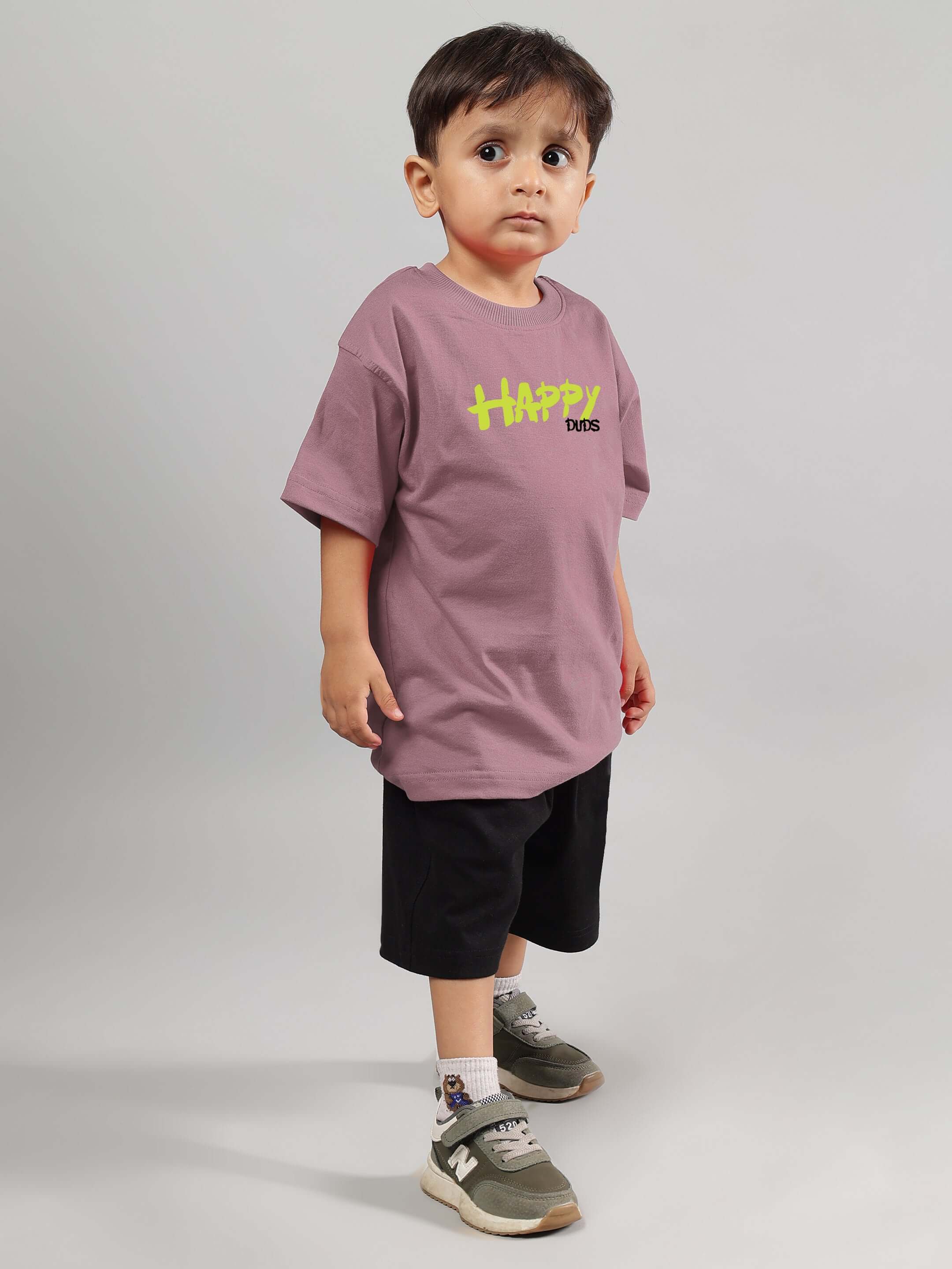 Child wearing a HAPPY DUDS oversized T-shirt in Chinese violet, perfect for boys and girls, showcasing casual fashion.