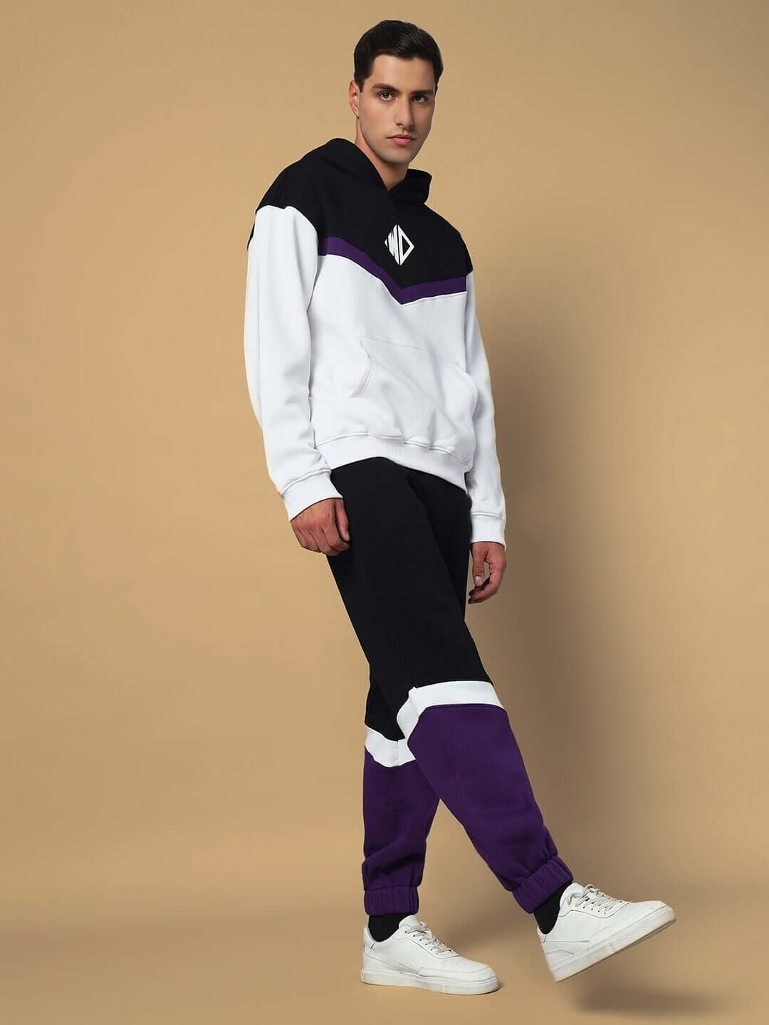 Model wearing HARLEY FLEECE COLORBLOCK HOODIE WHITE PURPLE with matching pants, showcasing trendy streetwear style.