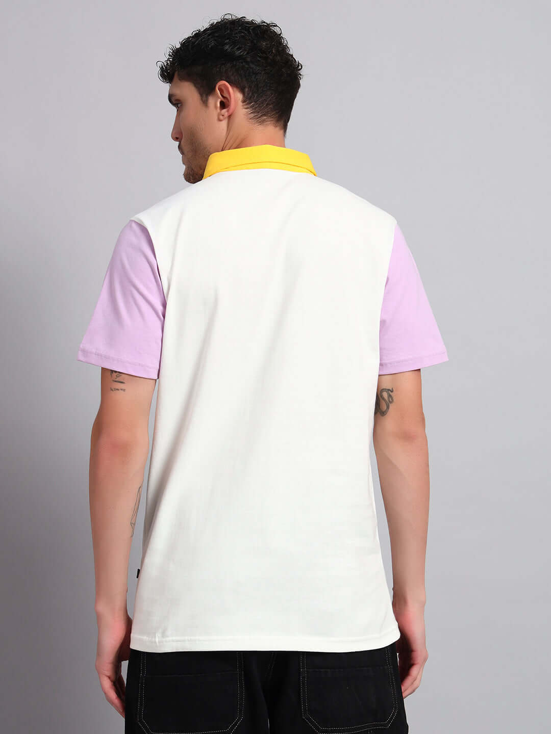 Back view of man wearing HARRY CONTRASTING POLO T-SHIRT OFF-WHITE with purple sleeves and yellow collar, perfect for all day comfort.