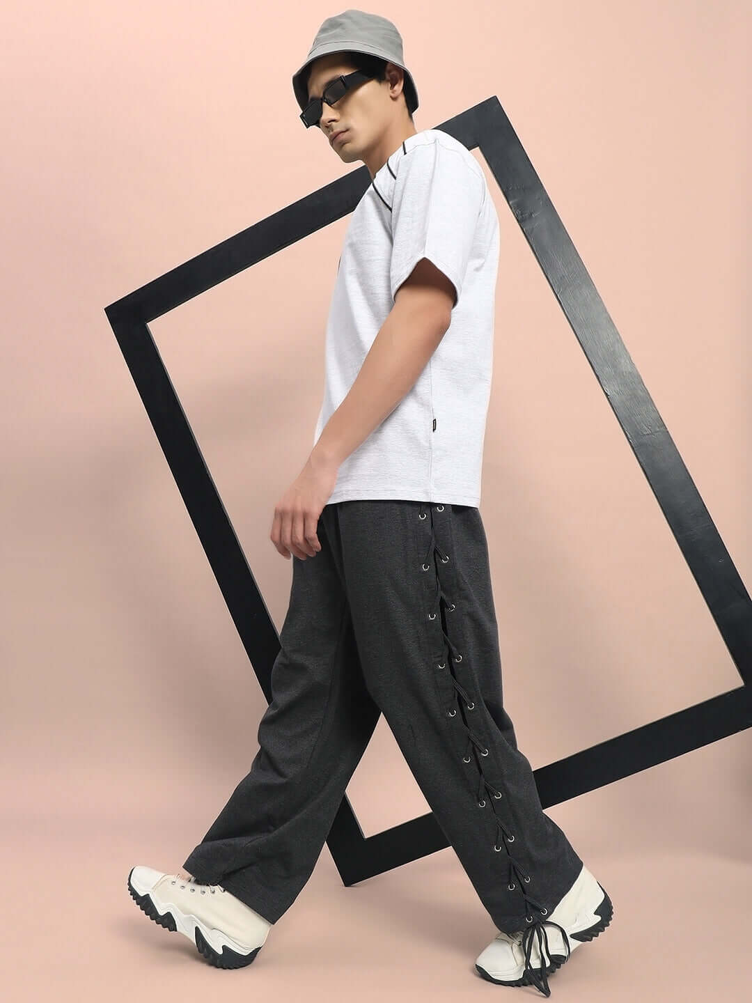 Model wearing Hazel Relaxed Fit Joggers in grey, showcasing comfortable style with lace detailing and a modern urban look.