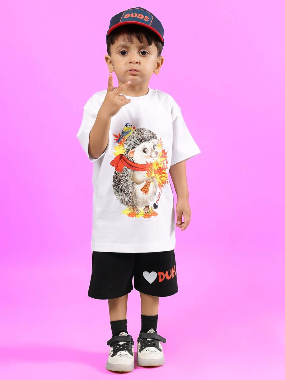 Child wearing HEDGEHOG CO-ORD FOR BOYS & GIRLS WHITE-BLACK clothing with a hedgehog print, offering custom fit option for prepaid orders.