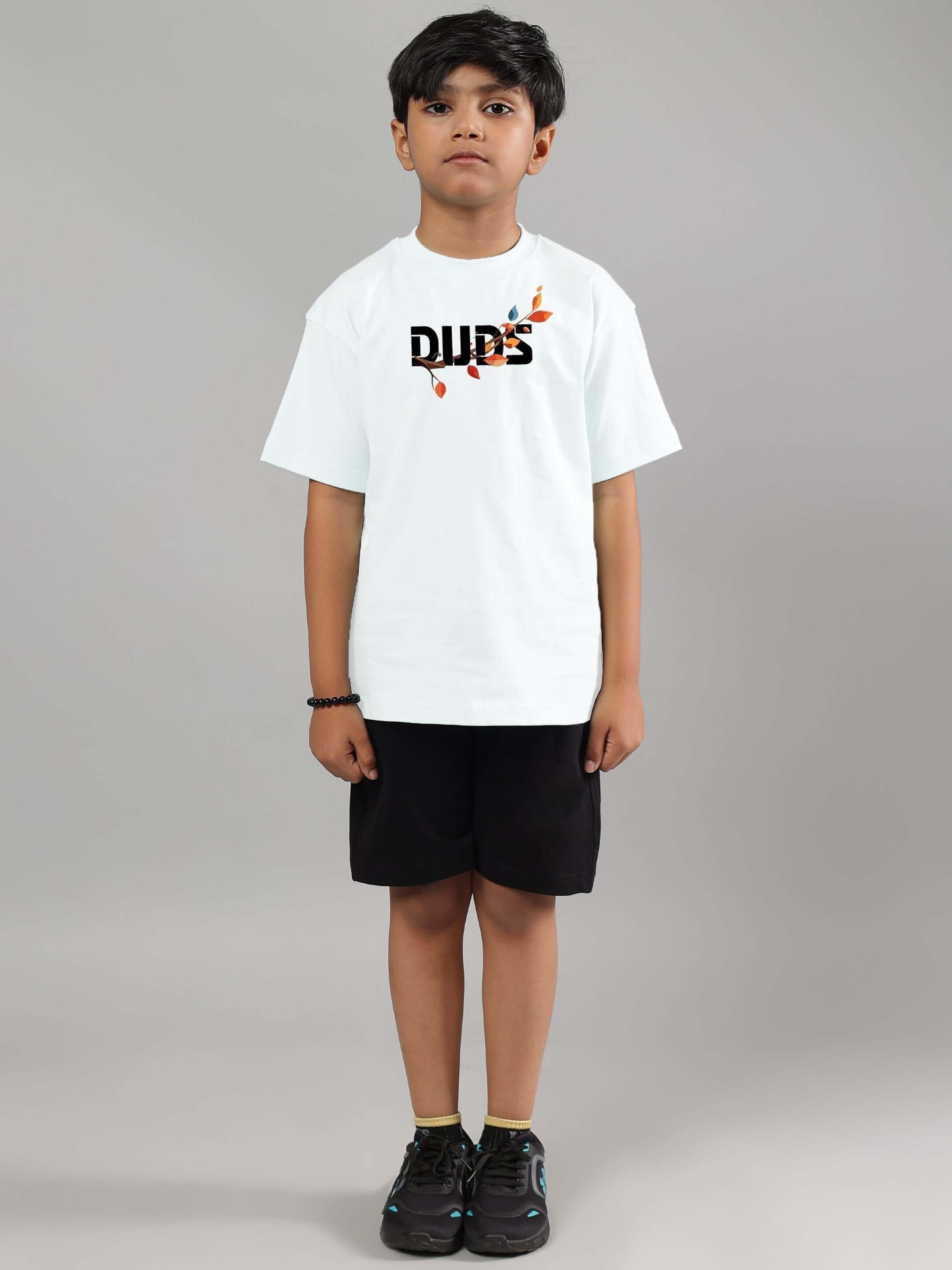 Young boy wearing a white Hedwig T-shirt for boys & girls by DUDS, showcasing custom fit clothing option.