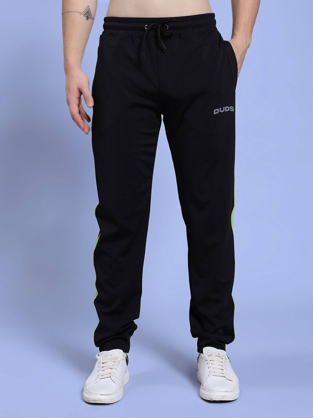 Man wearing HIGH PERFORMANCE CO-ORD SET BLACK joggers with white sneakers, perfect for athleisure wear and active lifestyle.