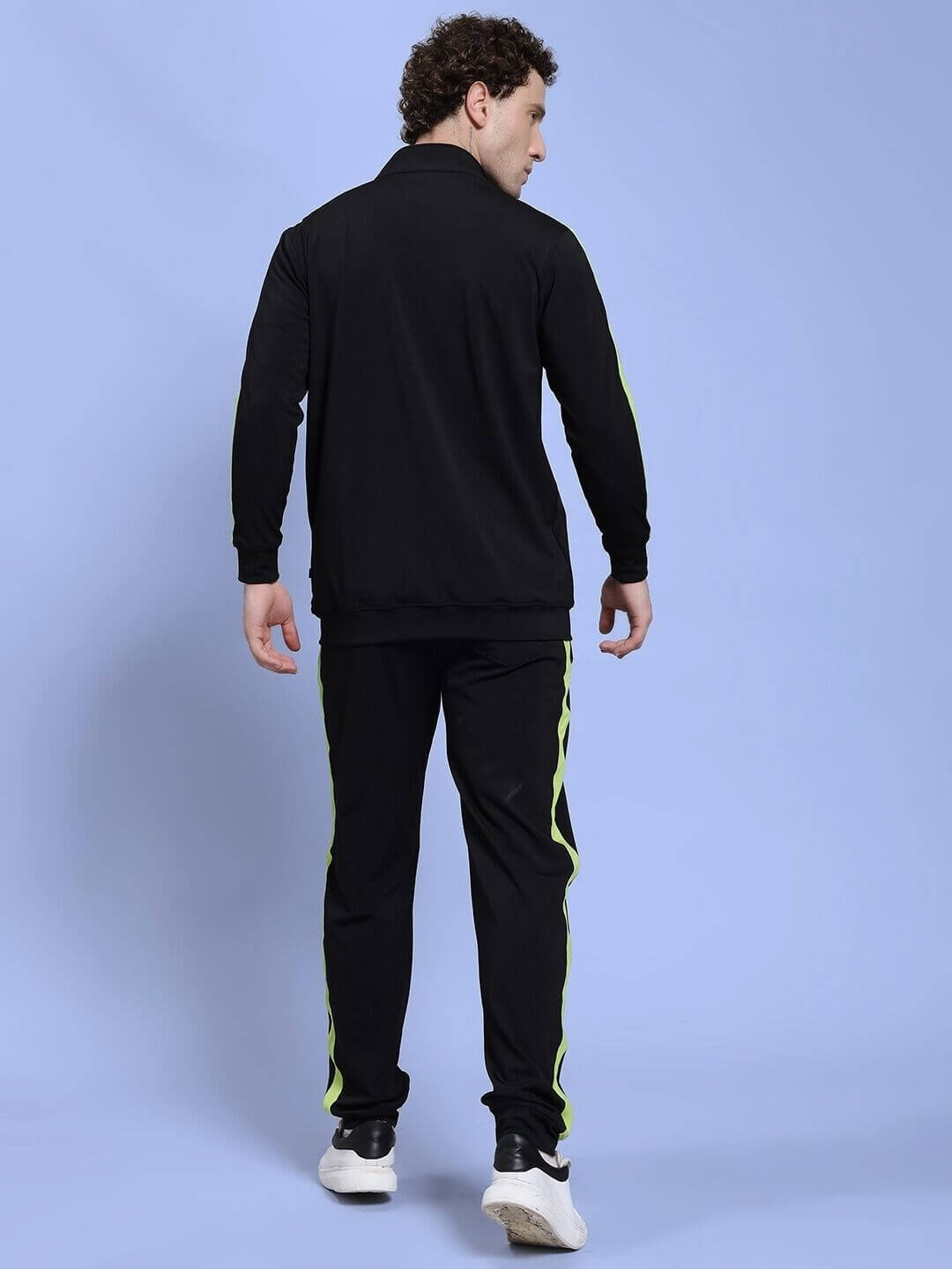 Rear view of person wearing HIGH PERFORMANCE CO-ORD SET BLACK, showcasing its sleek design and green accents.