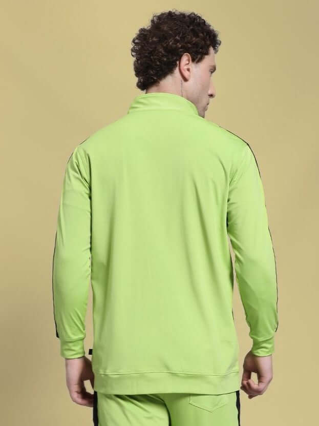 Back view of HIGH PERFORMANCE JACKET NEON GREEN worn by model against a neutral background.