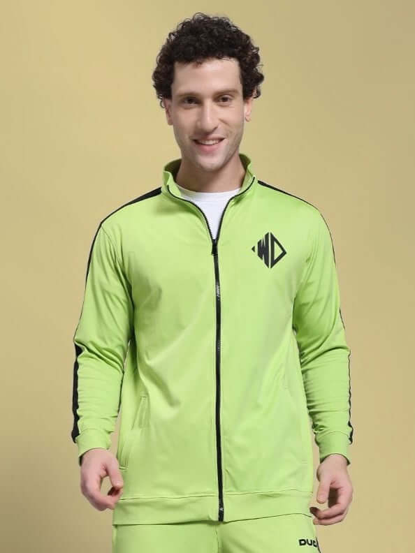 Man wearing HIGH PERFORMANCE JACKET NEON GREEN with black accents, ideal for athletes and urban explorers. Weather-resistant and fleece-lined.